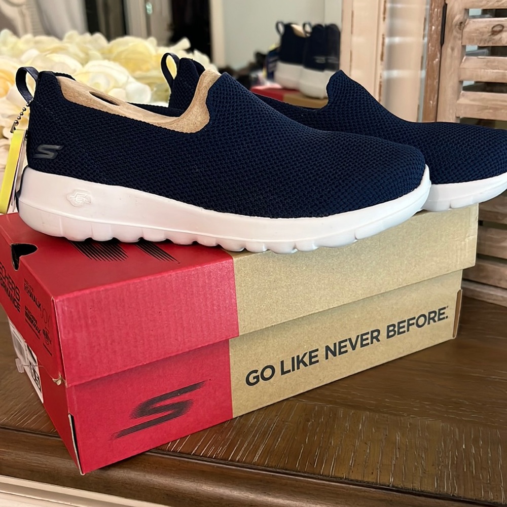 New in the box Sketchers navy slip on tennis shoes . Size 6.5